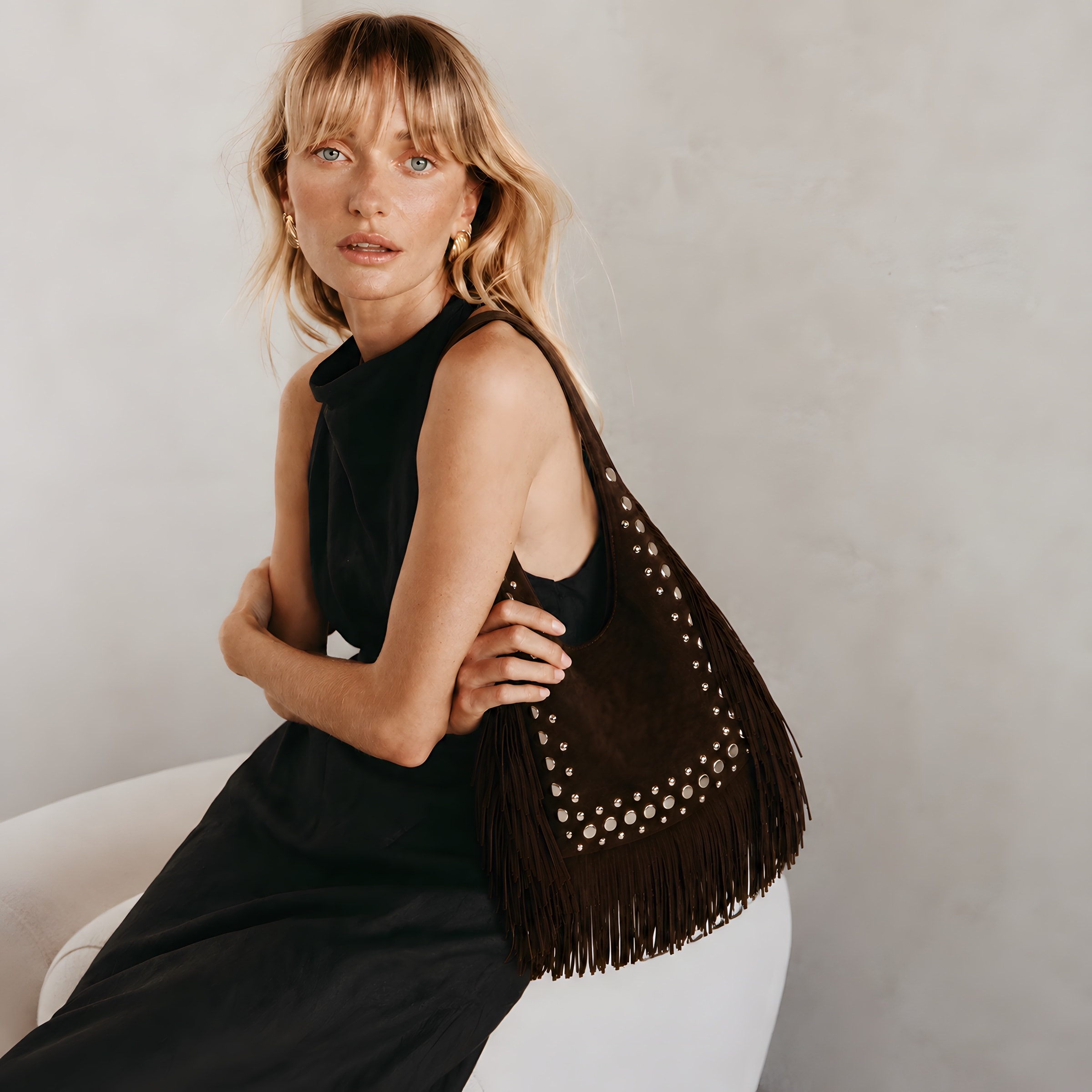 MARRAVA chocolate brown fringe bag styled with a black dress
